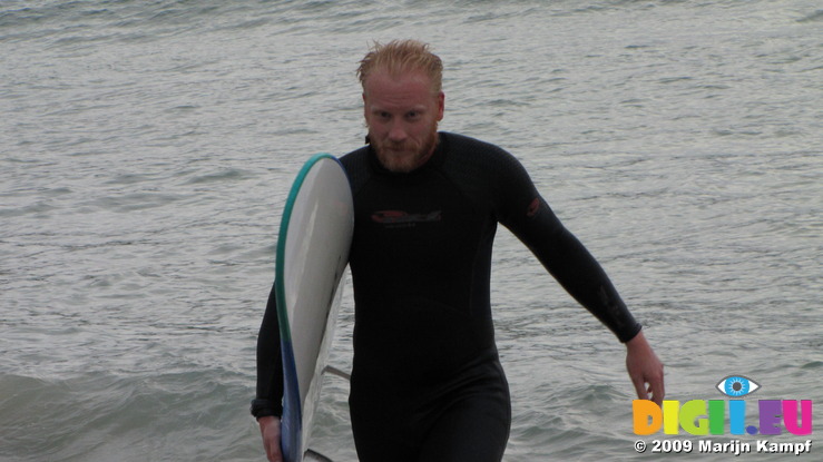 SX08870 Marijn with surfboard at Porth Beach, Newquay